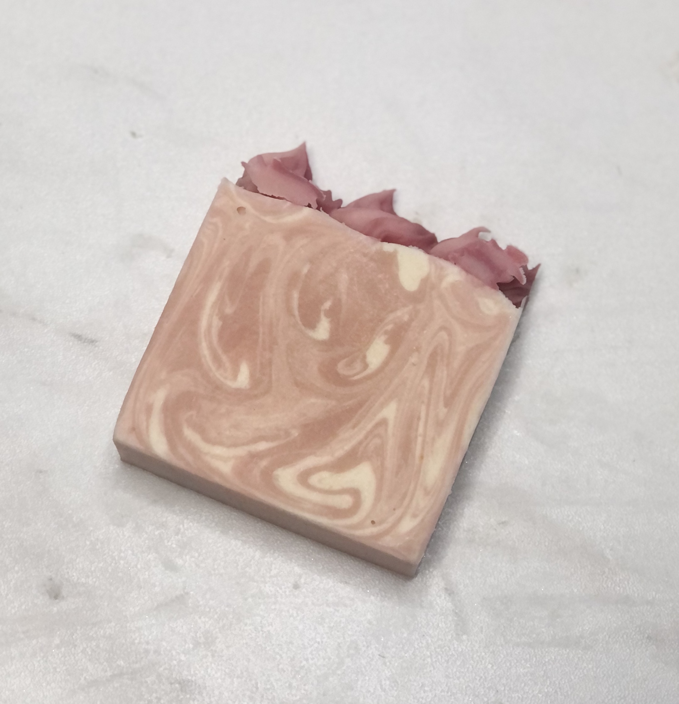 Sweetheart goat milk soap with pink and cream swirls and hand-piped soap top
