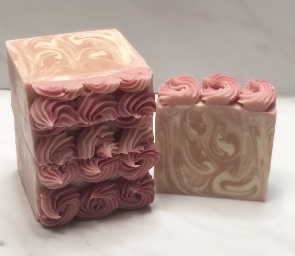 Sweetheart goat milk soap with pink and cream swirls and hand-piped soap top
