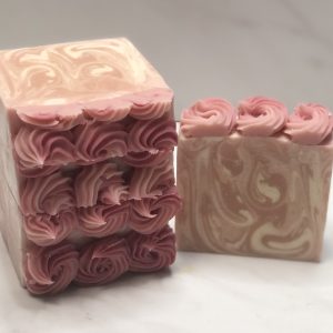 Sweetheart goat milk soap with pink and cream swirls and hand-piped soap top