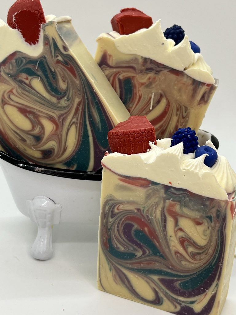 Berry Blast goat milk soap with colorful swirls and handcrafted berry soap toppings